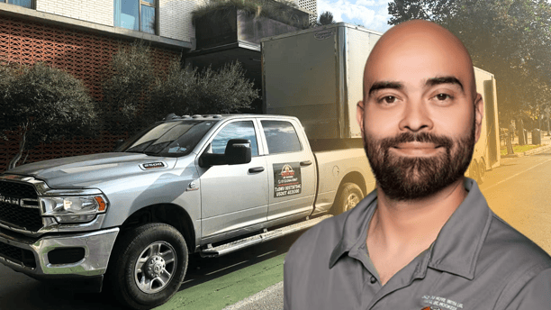 Moving Owner Jose in front of Hook Em Up truck and trailer